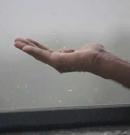Mão aberta recebe água da chuva
